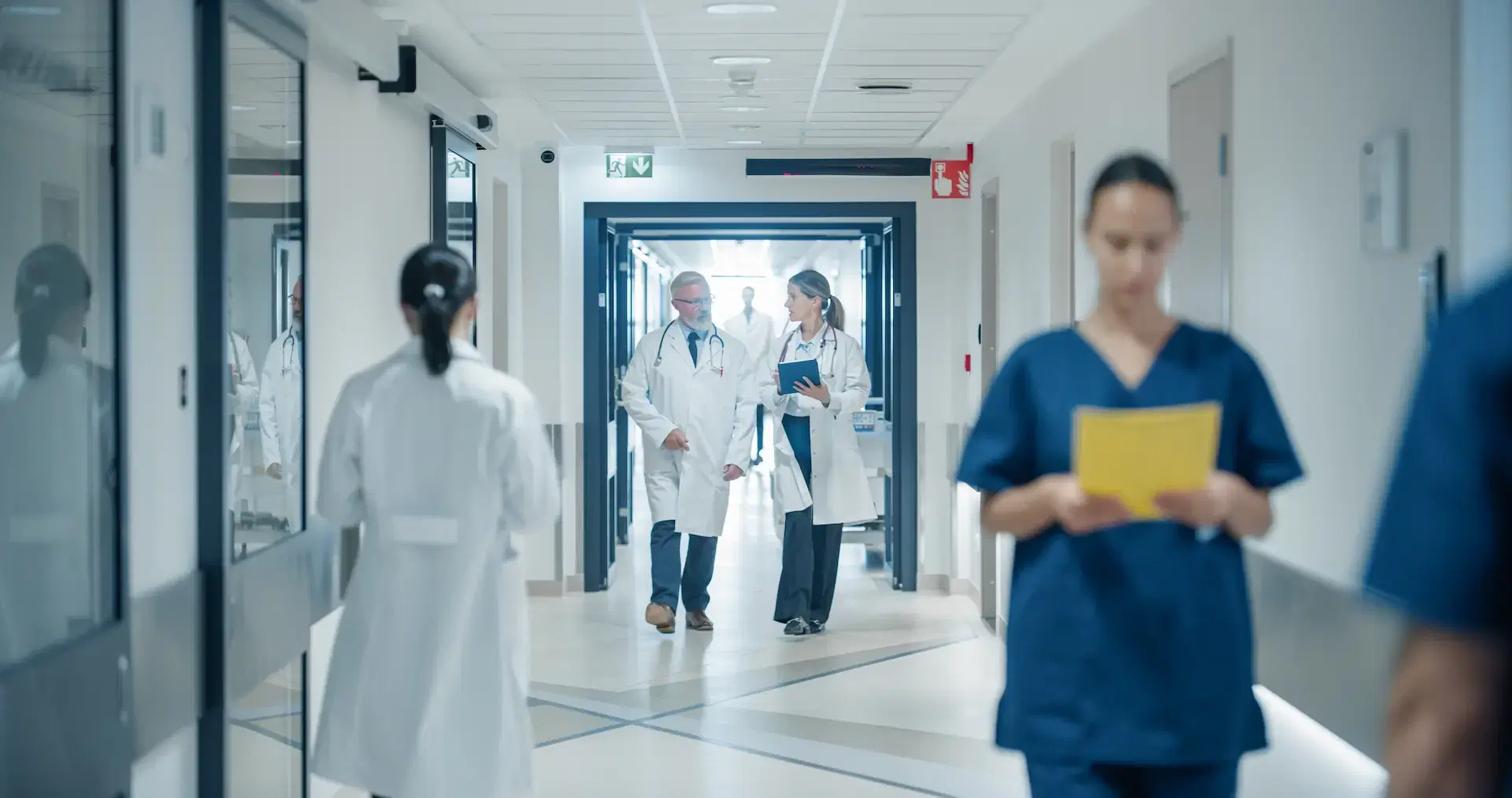 Doctors in busy hospital hallway